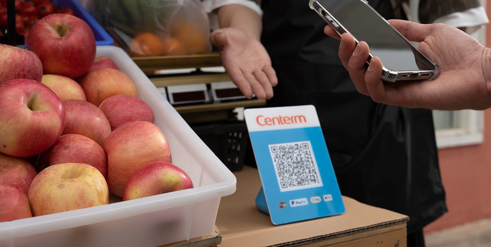 Scanning the S03 QR code at a fruit stall